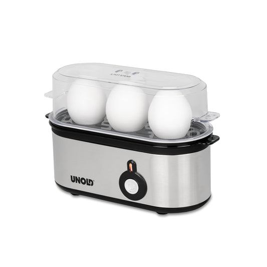 Der Unold Eierkocher Mini aus rostfreiem Stahl mit transparentem Deckel fasst drei weiße Eier. Er verfügt über eine Einschalttaste auf der Vorderseite und eine Kontrollleuchte, die auf weißem Hintergrund angezeigt wird.