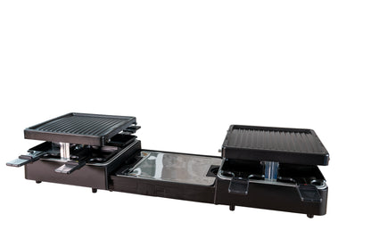 Der Unold Raclette Extendable ist ein schwarzer rechteckiger Tischgrill mit zwei Grillplatten, mehreren kleinen Unterschalen, einer zentralen Reflektorfläche und einem Heizelement aus Metall – ideal für geselliges Kochen.