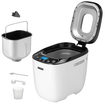 Der Brotbackautomat Unold AG 680101 Backmeister Design (B-Ware) in Weiß und Schwarz ist mit geöffnetem Deckel abgebildet, der den Blick auf die leere Backkammer freigibt. Daneben befinden sich eine herausnehmbare Backform, ein Knethaken, ein Messbecher, ein Löffel und ein kleines schwarzes Teil.