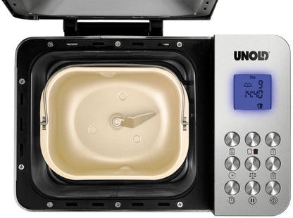 Draufsicht des Unold Backmeister® Edel Brotbackautomaten mit geöffneter beiger Brotbackform und Rührbesen. Rechts befindet sich ein Bedienfeld mit digitalem Display und Tasten, über dem der Markenname Unold zu sehen ist.