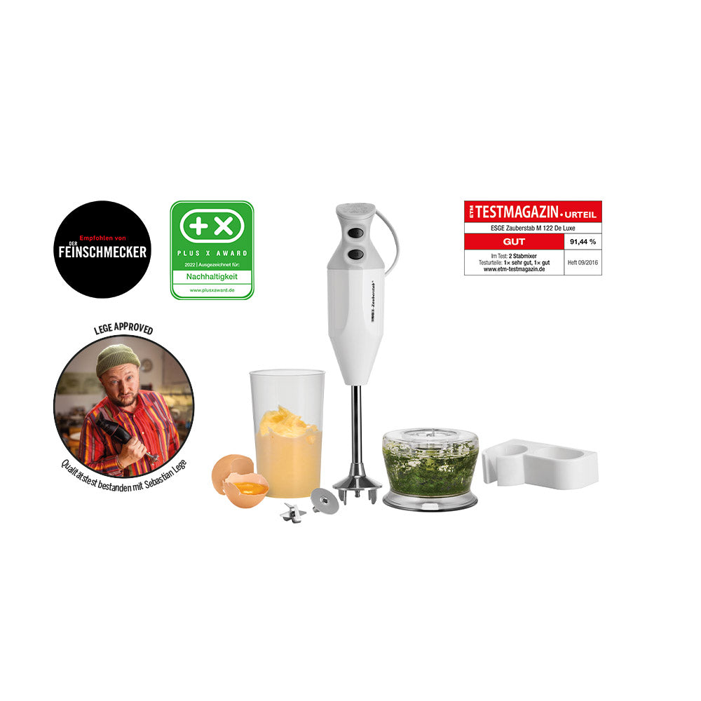 Der Unold ESGE-Zauberstab® M 122 De Luxe Stabmixer in Weiß, abgebildet mit mehreren Aufsätzen, gehackten Kräutern in einem Behälter, einer Tasse mit gemixtem Essen, Auszeichnungssiegeln, Foto des Kochs und einem roten Bewertungsaufkleber auf weißem Hintergrund.