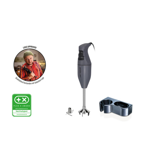 Der ESGE-Zauberstab M100 - Exklusiv Edition Anthrazit ist ein schwarzer Stabmixer mit einer Metallklinge, einer Wandhalterung und einer grünen Zertifizierungsplakette. Auf der linken Seite zeigt ein Foto einen lächelnden Koch in Streifen und Hut mit deutschem Text am Rand.