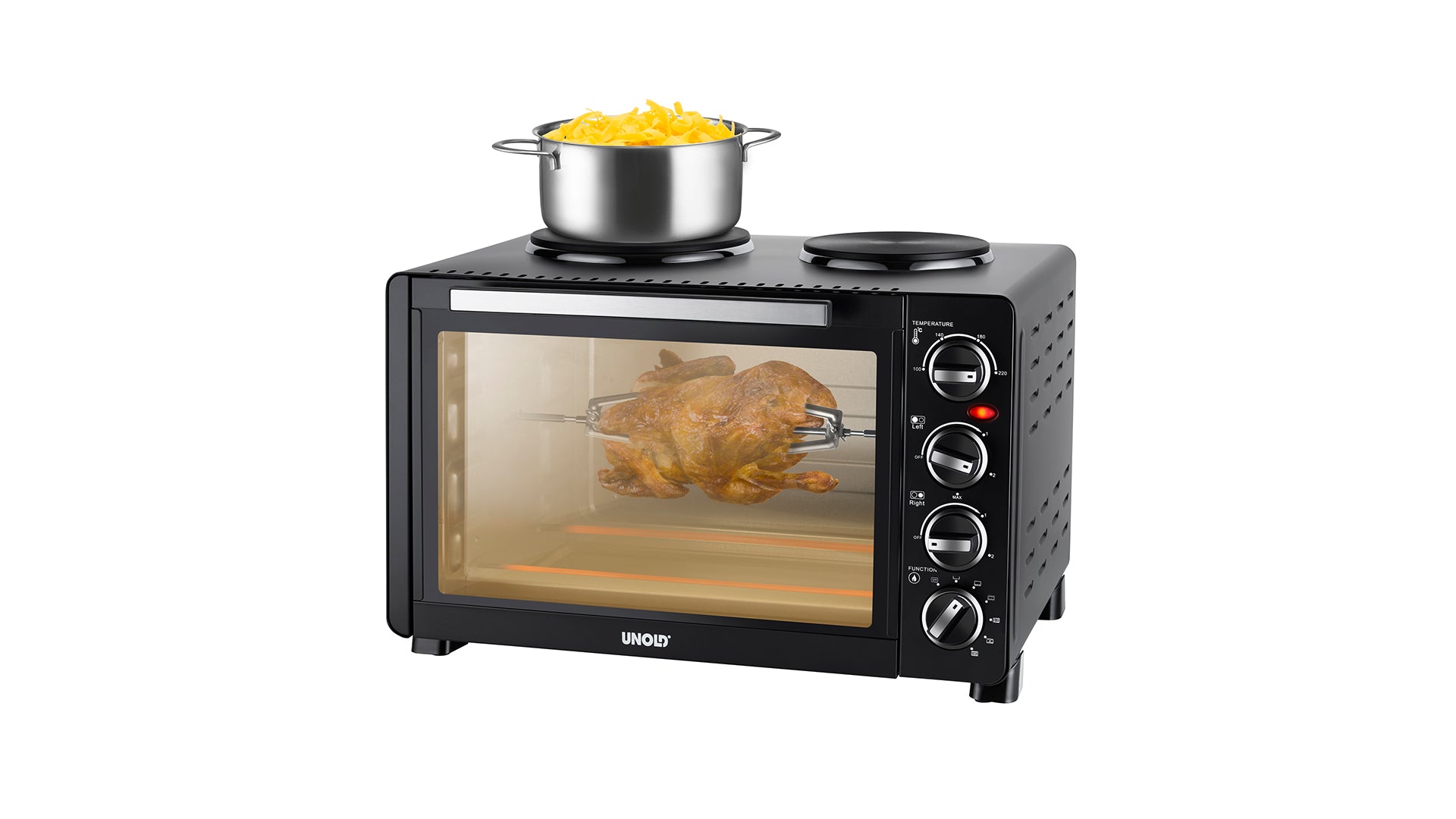 Ein schwarzer Tischbackofen mit einem Brathähnchen darin und einem Edelstahltopf mit gekochten Nudeln darauf; der Ofen hat Drehregler und eine Glastür, durch die man das Hähnchen sehen kann.