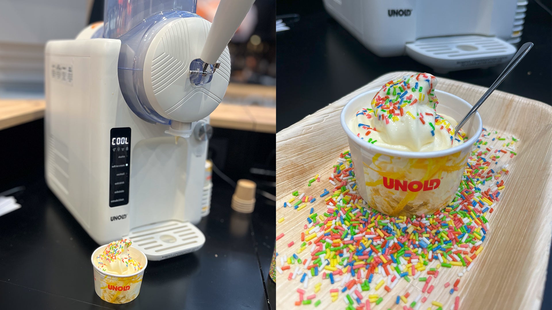Eine Softeismaschine füllt Vanilleeis in einen kleinen UNOLD-Becher, der auf einem mit bunten Streuseln bedeckten Tablett steht. Neben dem Eis liegt ein Löffel im Becher.